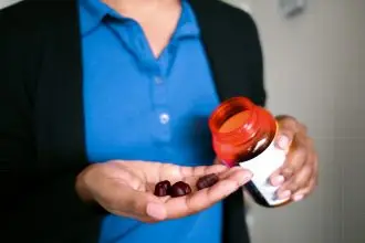 a photo of someone pouring elderberry gummies into their hand