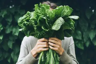 woman holding spinach