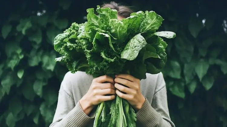 woman holding spinach