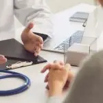 Image of a doctor explaining something to a patient