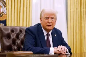 U.S. President Donald Trump speaks to reporters after signing a series of executive orders in the Oval Office of the White House.