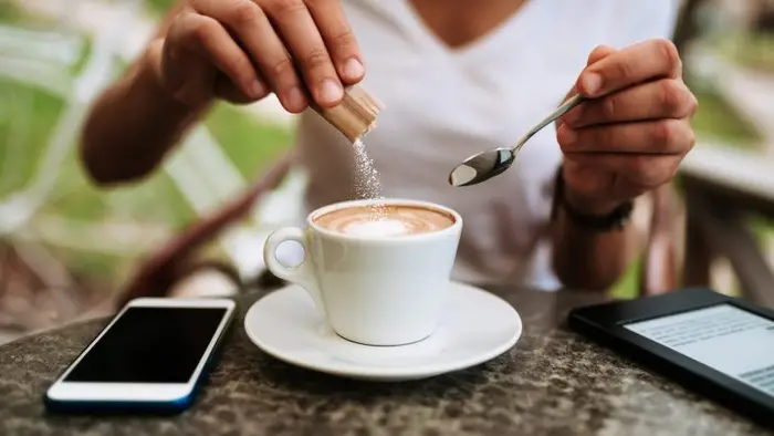 Sugar cubes, brown sugar crystals, granulated white sugar, rock sugar, stevia and honey. Different types of natural sweeteners.