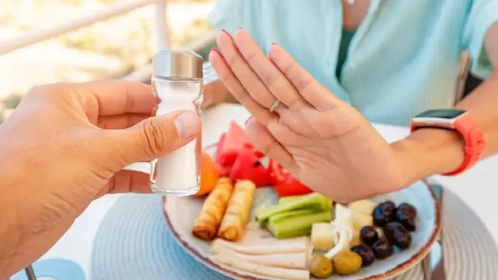 Woman saying no to table salt