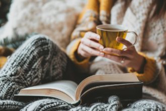 Woman drinking tea in bed.