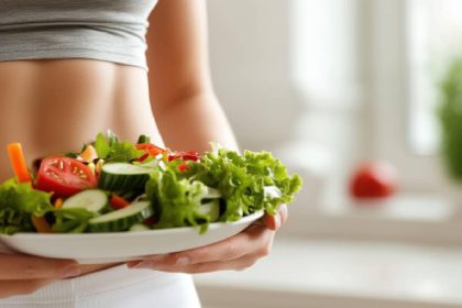 woman holding a plate of healthy food