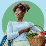 Young woman of color holding fresh produce in basket