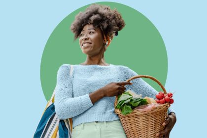 Young woman of color holding fresh produce in basket