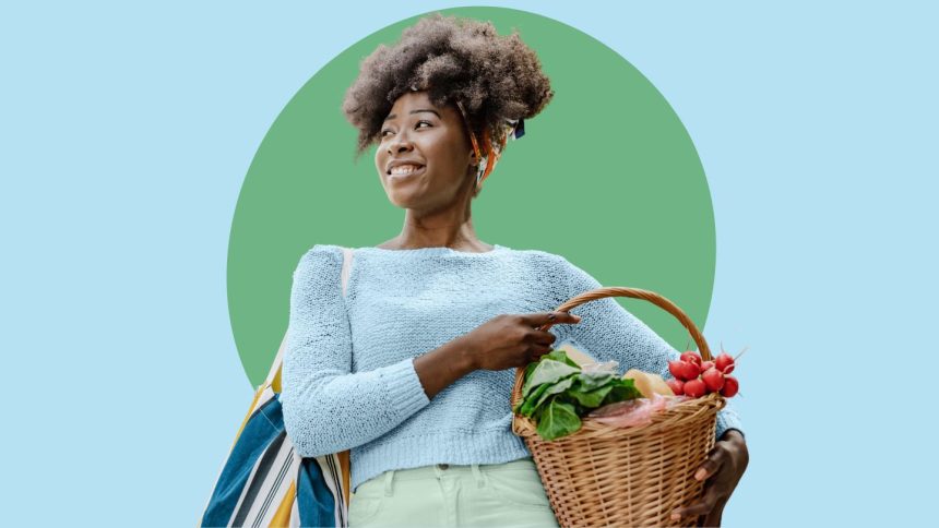 Young woman of color holding fresh produce in basket