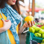 woman shopping for fruit at farmers market