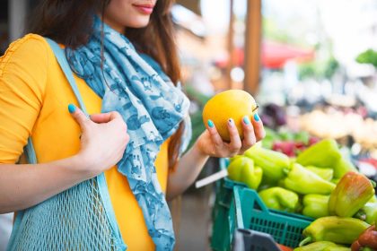 woman shopping for fruit at farmers market